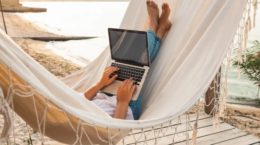 young-beautiful-woman-lying-hammock-with-laptop-resort-mock-up-blank-white-screen